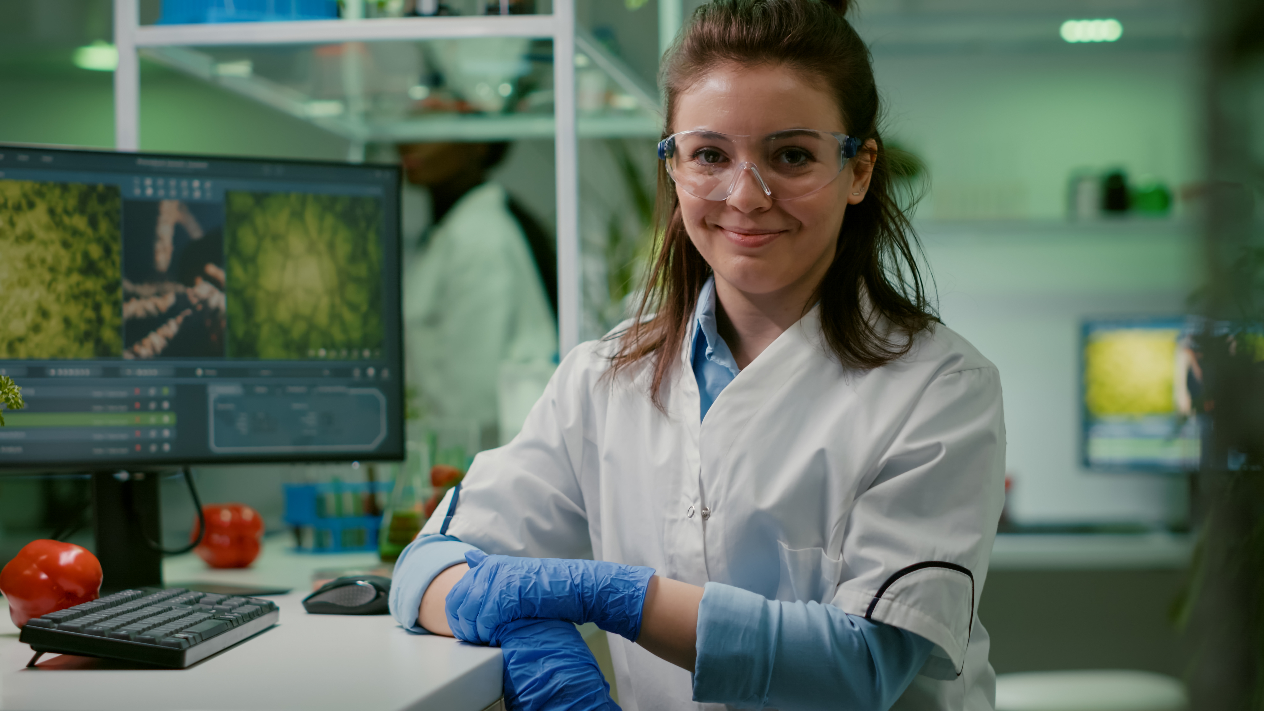 portrait-smiling-biologist-woman-analyzing-genetically-modified-organism 1.png